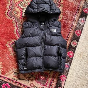 The North Face black puffy vest with a hood